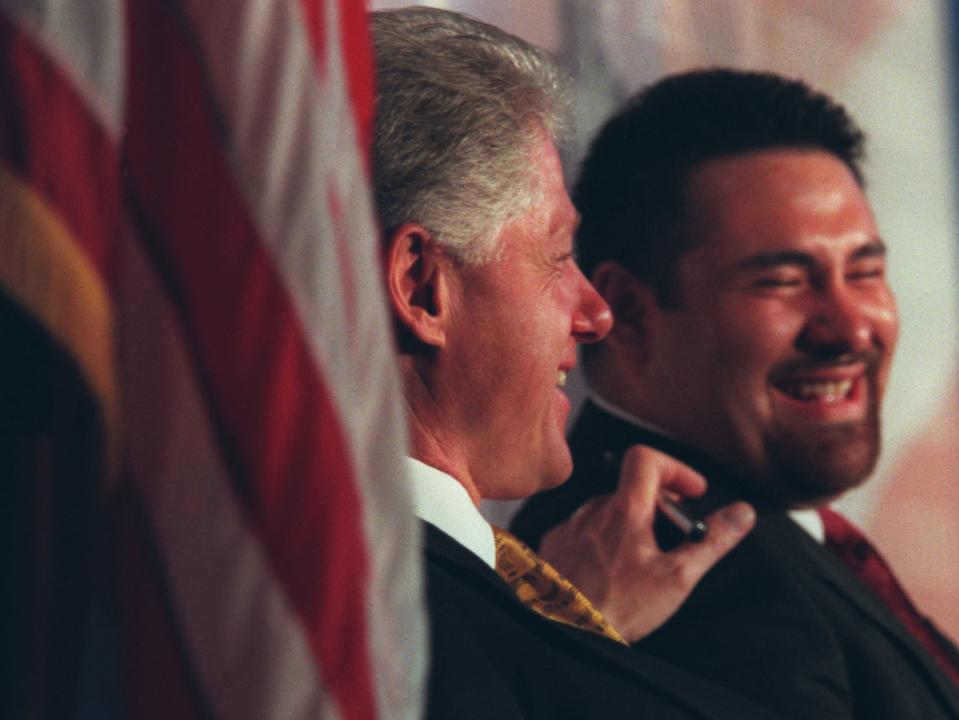President Clinton pats former City Academy student Thomas Gonzalez on the shoulder just before Gonzalez got up to introduce the president at City Academy charter school in St. Paul, the first charter school in the nation. (Photo By RITA REED/Star Tribune via Getty Images)